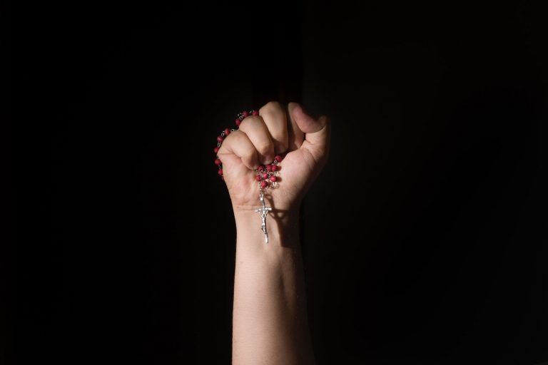 person holding a rosary